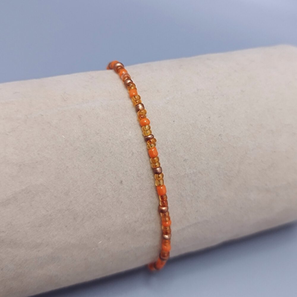 schmuckstück-mit-ziehverschluss-nahaufnahme Armband orange-gold-kupfer