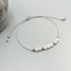 Textilarmband mit rosa Kristallperlen