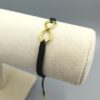 Minimalistisches Infinity Armband auf schwarzer Schnur Infinity Armband Makramee schwarz gold